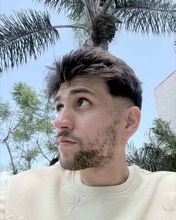 Alihan outdoors under a palm tree in California